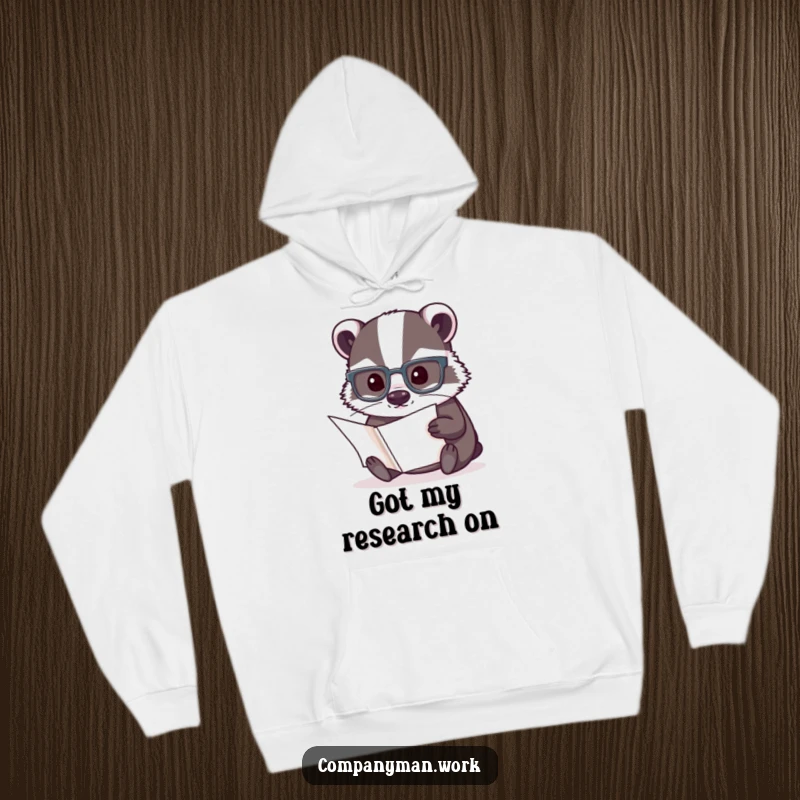 Funny hoodie featuring a concentrated badger in reading glasses examining a document, offering cozy and intelligent humor.